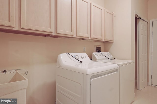 laundry area featuring washing machine and clothes dryer and cabinet space