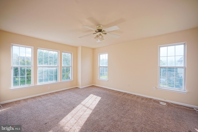 unfurnished room featuring carpet flooring, a ceiling fan, and baseboards