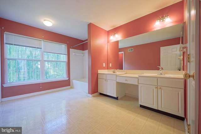 bathroom with tile patterned floors, double vanity, baseboards, and bathtub / shower combination