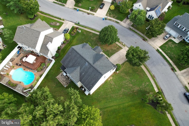 aerial view of property's location with a pool and nearby suburban area