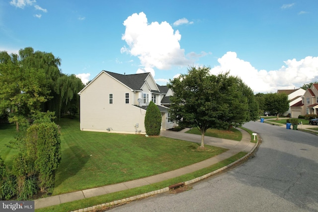 view of property exterior with a yard
