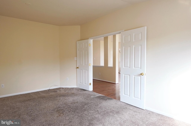 spare room with carpet and baseboards