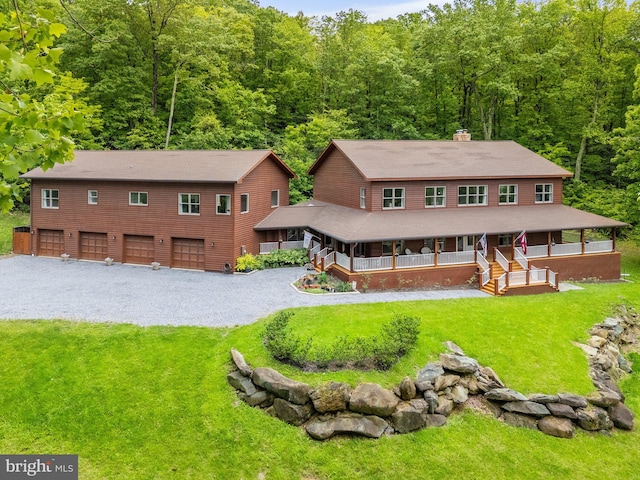 94 Tomahawk Way, Linden, VA 22642 - view of front of house with a porch, a wooded view, a chimney, and a front yard
