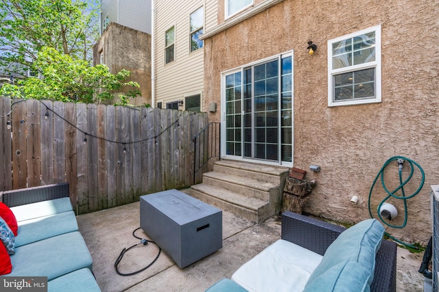 view of patio featuring entry steps and fence