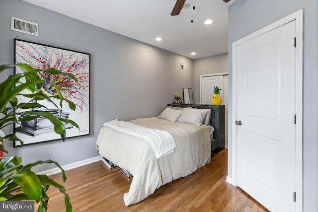 bedroom featuring wood finished floors, recessed lighting, baseboards, and ceiling fan