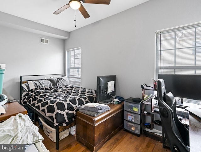 bedroom with wood finished floors, a desk, and ceiling fan