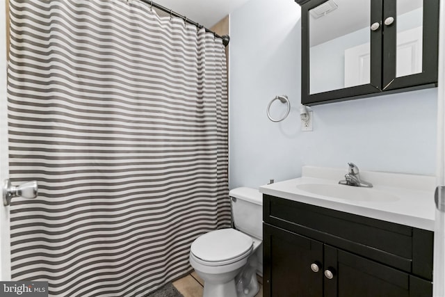 full bathroom with toilet, vanity, and tile patterned floors