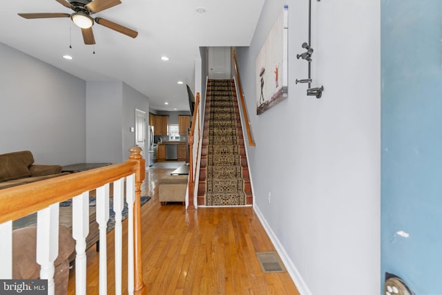 stairs with ceiling fan, hardwood / wood-style floors, baseboards, and recessed lighting