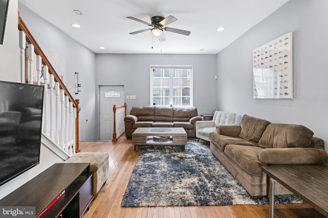 living area featuring stairway, ceiling fan, wood finished floors, and recessed lighting