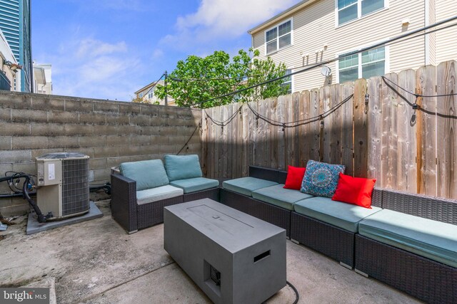 view of patio with central AC unit, an outdoor hangout area, and a fenced backyard