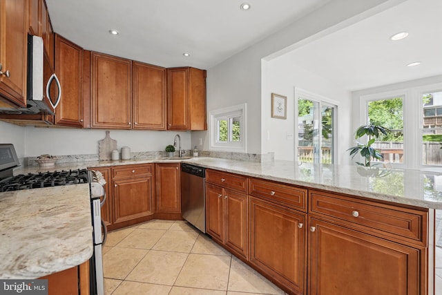 6924 Jefferson Ave, Falls Church, VA 22042 - kitchen with stainless steel appliances, a peninsula, a sink, brown cabinets, and light tile patterned flooring