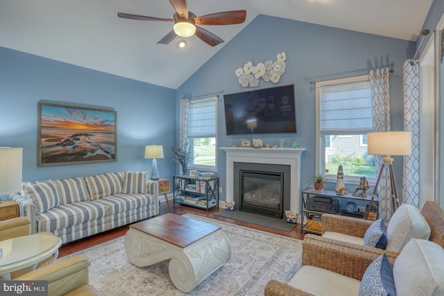 20785 Rodney Dr, Rehoboth Beach, DE 19971 - living room with ceiling fan, wood finished floors, a glass covered fireplace, and high vaulted ceiling
