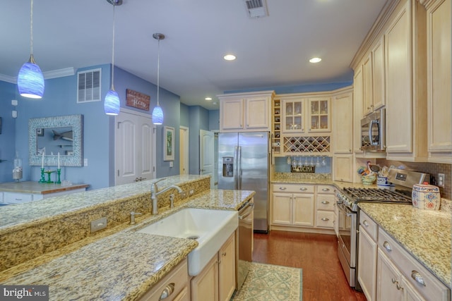 20785 Rodney Dr, Rehoboth Beach, DE 19971 - kitchen featuring appliances with stainless steel finishes, a sink, decorative backsplash, dark wood-style floors, and pendant lighting