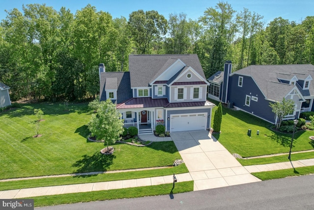 20785 Rodney Dr, Rehoboth Beach, DE 19971 - view of front facade featuring a standing seam roof, a chimney, driveway, covered porch, and a garage