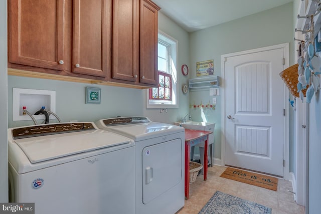 20785 Rodney Dr, Rehoboth Beach, DE 19971 - laundry room featuring cabinet space, washer and clothes dryer, light tile patterned flooring, and baseboards