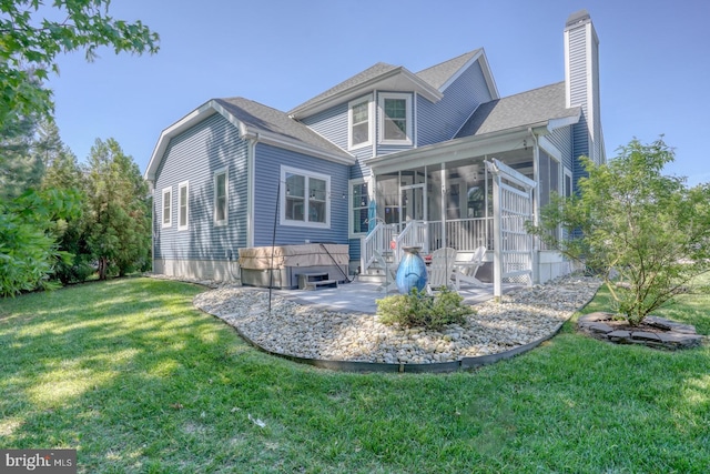 20785 Rodney Dr, Rehoboth Beach, DE 19971 - rear view of house with a chimney, a sunroom, a patio, and a yard