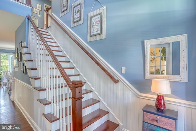 20785 Rodney Dr, Rehoboth Beach, DE 19971 - stairway featuring a wainscoted wall and wood finished floors