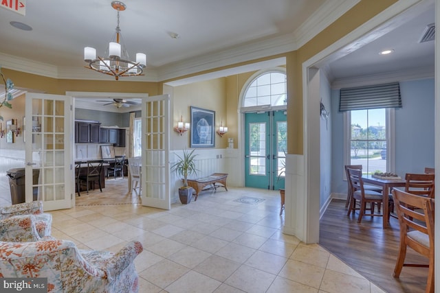 20785 Rodney Dr, Rehoboth Beach, DE 19971 - entryway with french doors, a chandelier, ornamental molding, light tile patterned floors, and ceiling fan