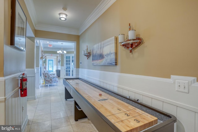 20785 Rodney Dr, Rehoboth Beach, DE 19971 - rec room with a chandelier, ornamental molding, wainscoting, and light tile patterned flooring