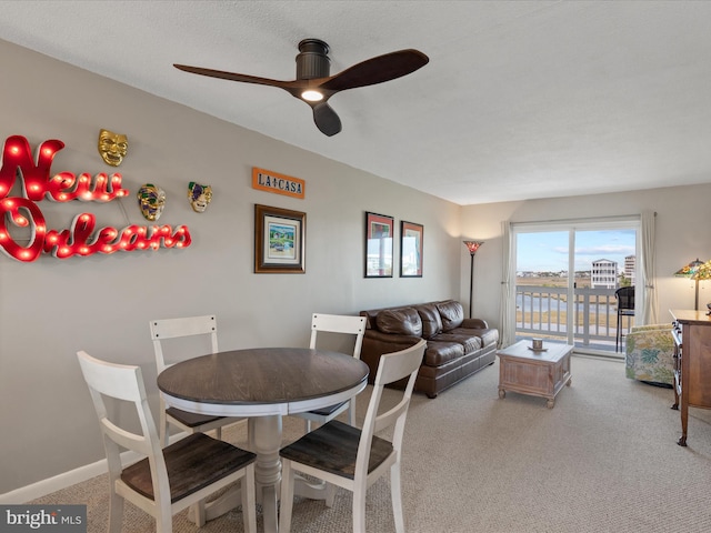 117 76th St Unit 302, Ocean City, MD 21842 - carpeted dining room featuring a ceiling fan, a water view, and baseboards