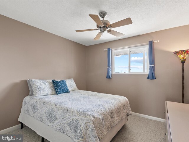 117 76th St Unit 302, Ocean City, MD 21842 - bedroom featuring light carpet, baseboards, and ceiling fan
