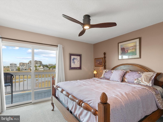 117 76th St Unit 302, Ocean City, MD 21842 - bedroom with access to exterior, carpet floors, ceiling fan, and a textured ceiling