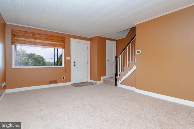 7813 E Baltimore St, Baltimore, MD 21224 - carpeted entryway with baseboards, crown molding, and stairway