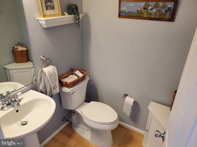 225 Canonero Dr, Bear, DE 19701 - half bathroom with a sink, wood finished floors, baseboards, and toilet