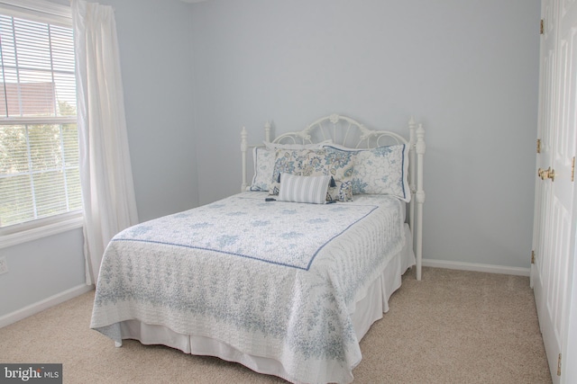 225 Canonero Dr, Bear, DE 19701 - bedroom with light colored carpet, multiple windows, and baseboards