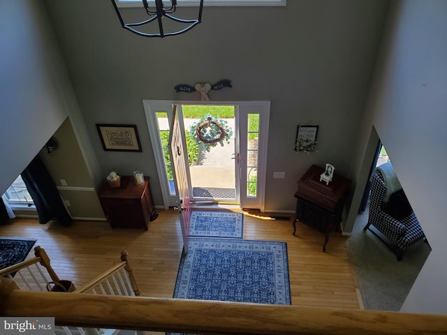 225 Canonero Dr, Bear, DE 19701 - entryway with a high ceiling, hardwood / wood-style flooring, a chandelier, and baseboards