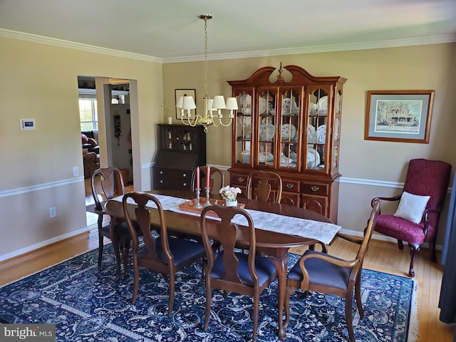 225 Canonero Dr, Bear, DE 19701 - dining space with a chandelier, wood finished floors, baseboards, and crown molding
