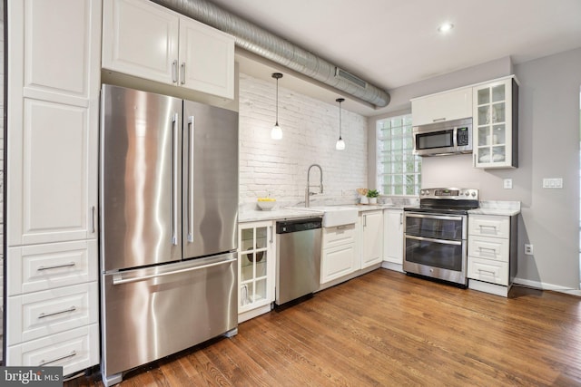 223 Parker St NE, Washington, DC 20002 - kitchen with appliances with stainless steel finishes, a sink, white cabinets, glass insert cabinets, and wood finished floors