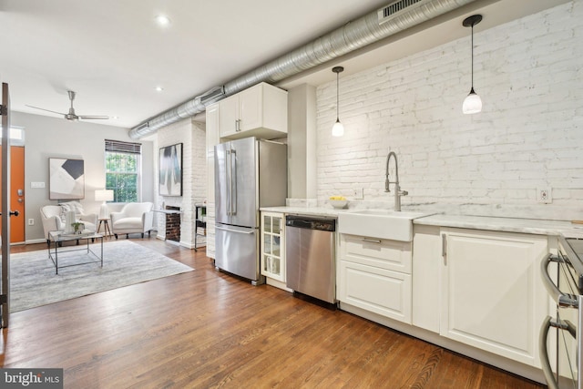 223 Parker St NE, Washington, DC 20002 - kitchen with stainless steel appliances, a sink, brick wall, ceiling fan, and open floor plan