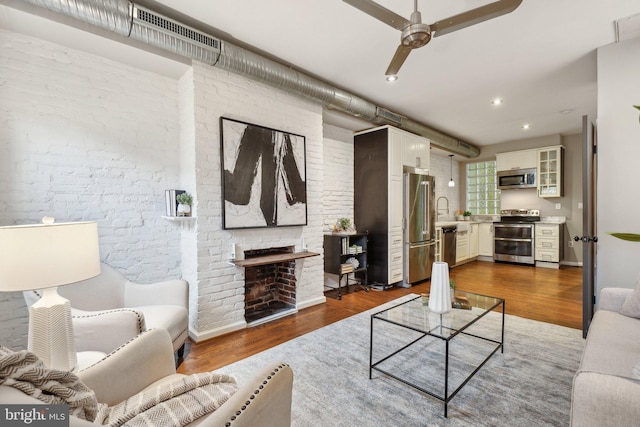 223 Parker St NE, Washington, DC 20002 - living area with wood finished floors, ceiling fan, brick wall, recessed lighting, and a fireplace