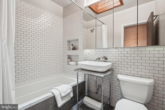 223 Parker St NE, Washington, DC 20002 - full bathroom with tile walls, toilet, tiled shower / bath, a sink, and decorative backsplash