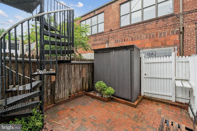 223 Parker St NE, Washington, DC 20002 - view of patio with a fenced backyard, an outdoor structure, and a storage shed
