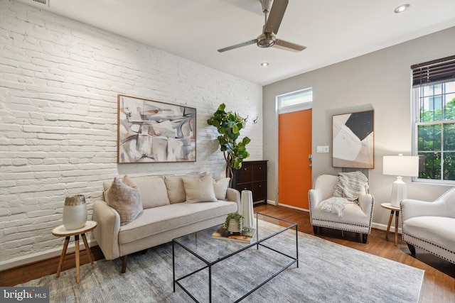 223 Parker St NE, Washington, DC 20002 - living area with plenty of natural light, brick wall, wood finished floors, ceiling fan, and baseboards