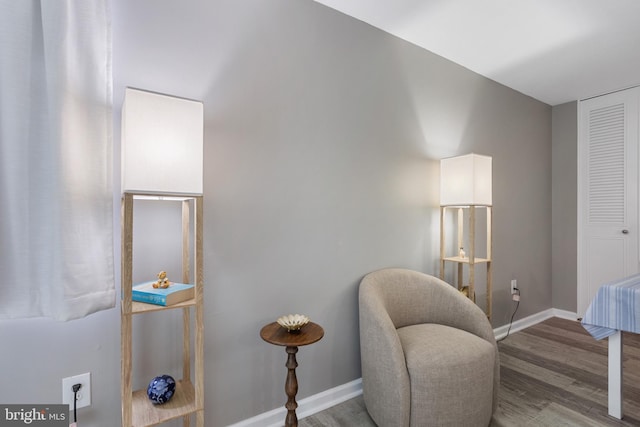 living area featuring wood finished floors and baseboards