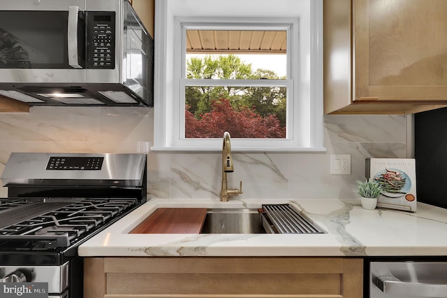 2129 Saranac St, Hyattsville, MD 20783 - kitchen featuring stainless steel appliances, backsplash, a sink, and light stone countertops