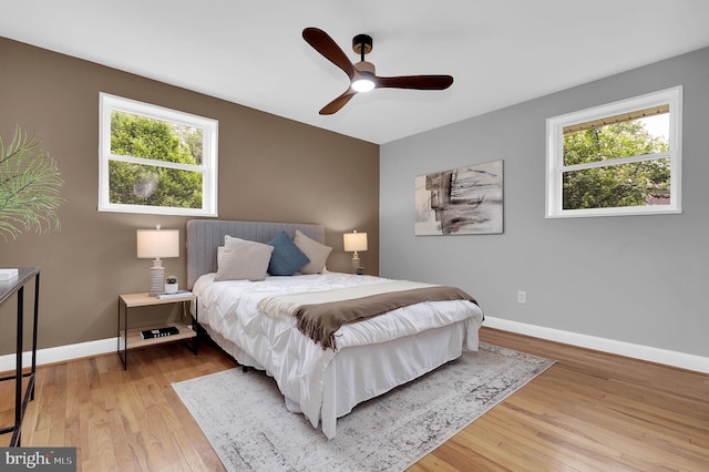 2129 Saranac St, Hyattsville, MD 20783 - bedroom featuring light wood-style flooring, multiple windows, baseboards, and a ceiling fan