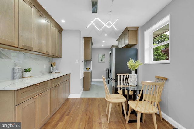 2129 Saranac St, Hyattsville, MD 20783 - kitchen with light wood-type flooring, freestanding refrigerator, light stone countertops, baseboards, and recessed lighting