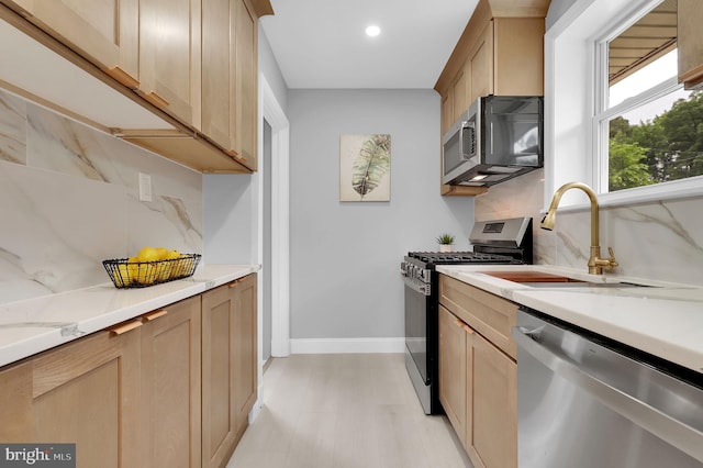 2129 Saranac St, Hyattsville, MD 20783 - kitchen featuring appliances with stainless steel finishes, a sink, decorative backsplash, baseboards, and recessed lighting