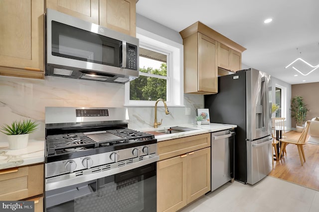 2129 Saranac St, Hyattsville, MD 20783 - kitchen featuring appliances with stainless steel finishes, light brown cabinetry, a sink, backsplash, and recessed lighting