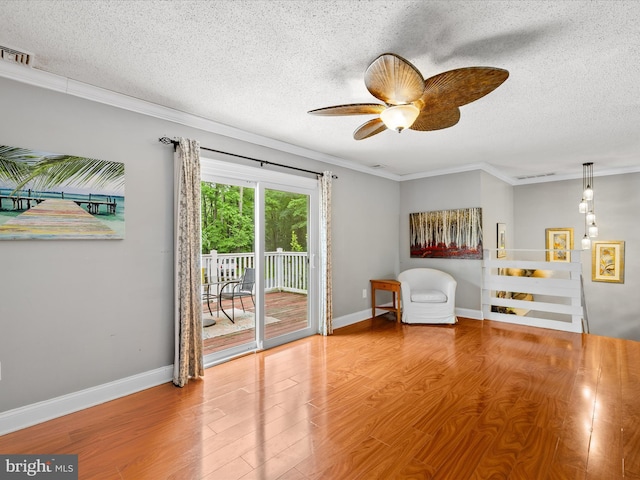35775 Clam Ave, Frankford, DE 19945 - living area with a textured ceiling, wood finished floors, ornamental molding, ceiling fan, and baseboards