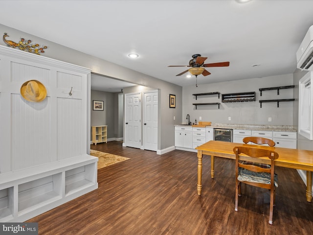 35775 Clam Ave, Frankford, DE 19945 - dining room featuring bar with sink, dark wood finished floors, ceiling fan, a wall unit AC, and wine cooler