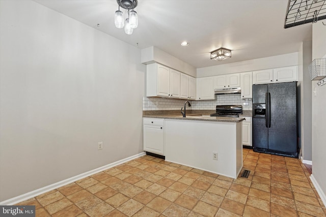 131 Red Haven Dr, North Wales, PA 19454 - kitchen featuring black fridge with ice dispenser, stove, under cabinet range hood, a peninsula, and tasteful backsplash