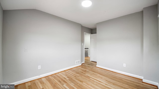 7913 Charlesmont Rd, Baltimore, MD 21222 - empty room featuring wood finished floors, baseboards, and lofted ceiling