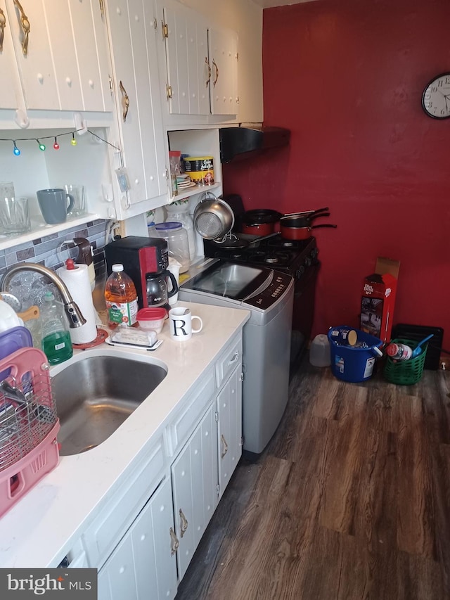 8231 Craig St, Philadelphia, PA 19136 - kitchen featuring dark wood-type flooring, white cabinetry, a sink, light countertops, and washer / clothes dryer