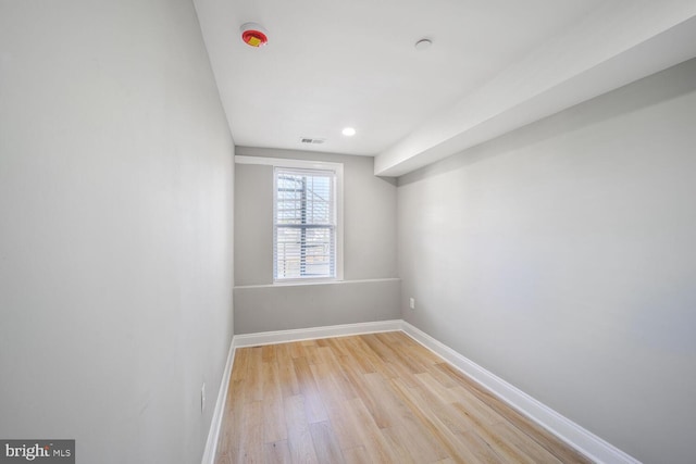 spare room with light wood-style flooring, baseboards, and recessed lighting