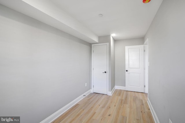 unfurnished bedroom featuring light wood-style flooring and baseboards